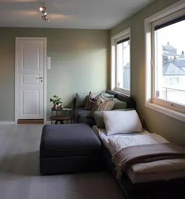 a living room with a couch and a window at City View Studio Apartment in Ålesund