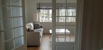 a living room with a couch and a table at Voss Interlake - Villa in Skulestadmo