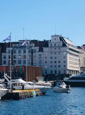 a group of boats docked in a harbor with buildings at Magic Kloverhuset Harbour Hotel, a member of Radisson Individuals in Bergen