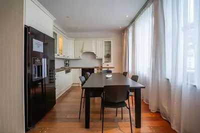 a kitchen and dining room with a table and chairs at Prize by Radisson, Xhibition Bergen City in Bergen