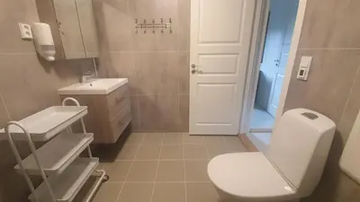 a bathroom with a white toilet and a sink at Olden Camping in Olden
