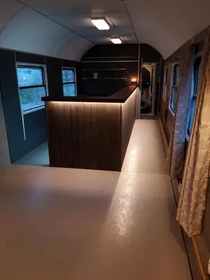 an empty train car with a hallway and a counter at Veggli Vertshus in Veggli