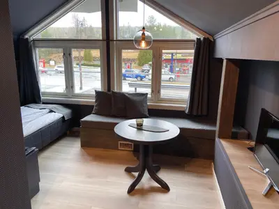 a small living room with a table and a couch at Veggli Vertshus in Veggli