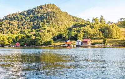 a group of houses on the shore of a lake at Gorgeous Home In Førde I Hordaland in Førde