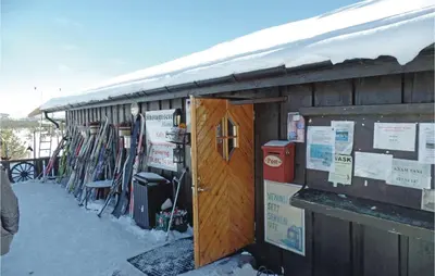 a building with a bunch of skis leaning against it at Amazing Home In Kvam With Kitchen in Kvam