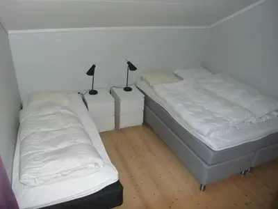 a bedroom with two beds and two lamps in it at Mørkve Apartement in Myrkdalen