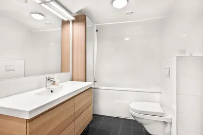 a bathroom with a white sink and a toilet at Namsos Hybelhus in Namsos
