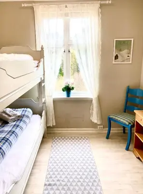 a bedroom with a bunk bed and a window at Fjord View Apartment in Stranda