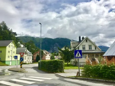 a town with a crosswalk in the middle of a street at Fjord View Apartment in Stranda