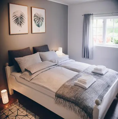 a bedroom with a large bed with two towels on it at Dalhus - House with jacuzzi in Norddal