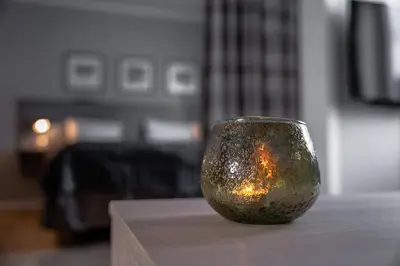 a glass vase sitting on top of a table at Birkebeineren Hotel & Apartments in Lillehammer
