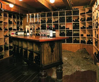 a bar in a wine cellar with wine glasses at Kviknes Hotel in Balestrand