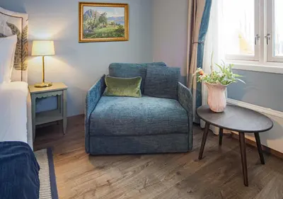 a living room with a chair and a table at Hotel Breiseth in Lillehammer