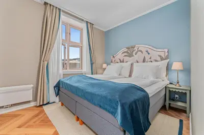 a bedroom with a large bed and a window at Hotel Breiseth in Lillehammer