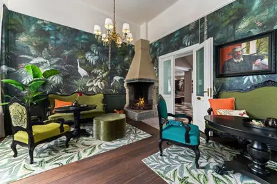 a living room with a wall mural with a fireplace at Hotel Breiseth in Lillehammer