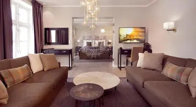 a living room with a couch and a table at Home Hotel Hammer in Lillehammer