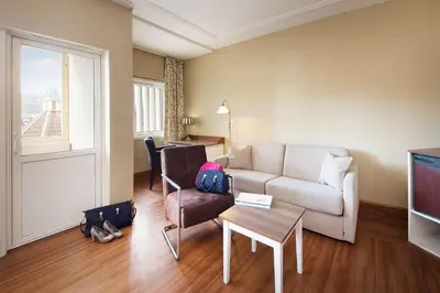a living room with a couch and a table at Scandic Valdres in Fagernes