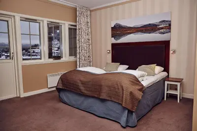 a bedroom with a large bed in front of a window at Scandic Valdres in Fagernes