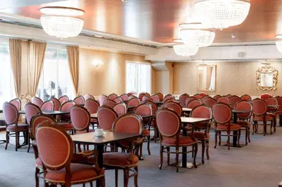 a room with rows of tables and chairs at Scandic Valdres in Fagernes