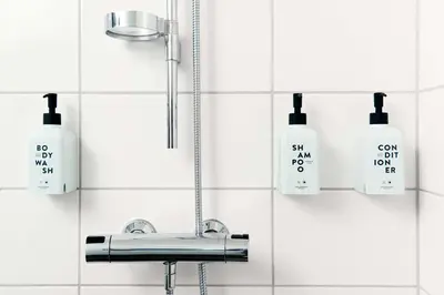 a bathroom with a sink and soap bottles on the wall at Scandic Hafjell in Hafjell