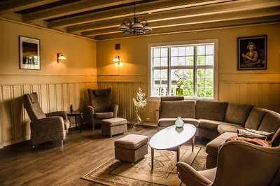 a living room with a couch and chairs and a table at Valldal Fjord Lodge B&B in Valldal