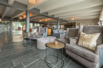 a lobby with couches and tables in a building at Beito Resort Hotel in Beitostøl