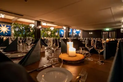 a table with wine glasses and a candle on it at Beito Resort Hotel in Beitostøl