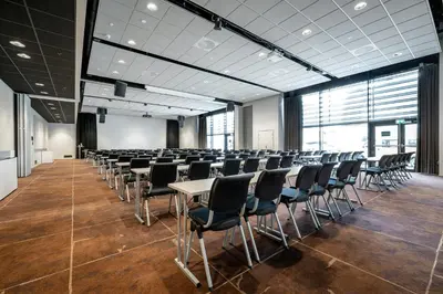 a room with rows of tables and chairs in a room at Quality Airport Hotel Værnes in Stjoerdal