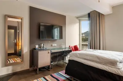 a hotel room with a bed and a desk at Clarion Hotel Admiral in Bergen
