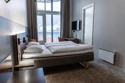 a bedroom with a bed with a large window at Comfort Hotel Bergen in Bergen