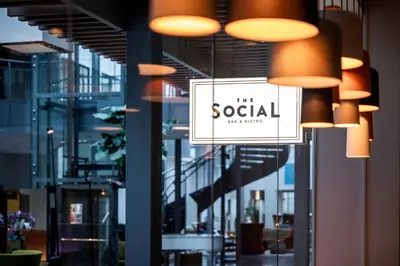 a sign that reads the social hanging in a building at Quality Hotel Edvard Grieg in Bergen