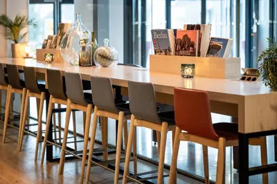 a wooden table with chairs in a room at Quality Hotel Edvard Grieg in Bergen