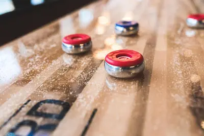 a group of red and silver knobs on a wooden table at Quality Hotel Edvard Grieg in Bergen