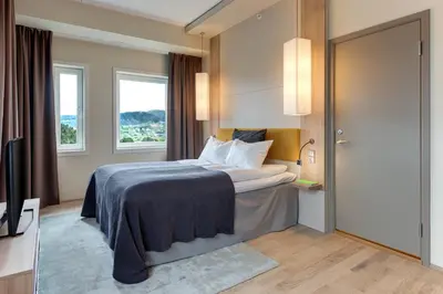 a hotel room with a bed and a television at Quality Hotel Edvard Grieg in Bergen
