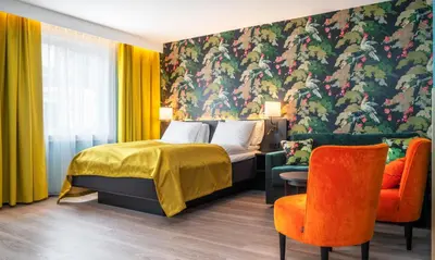 a hotel room with a bed and a chair at Thon Hotel Bristol, Bergen in Bergen