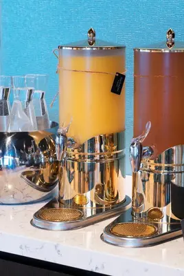 a group of silver and gold drums on a table at Thon Hotel Bristol, Bergen in Bergen
