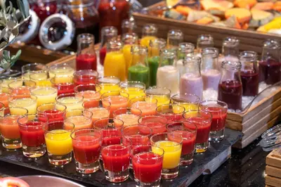 a bunch of glasses filled with different types of drinks at Thon Hotel Bergen Airport in Bergen