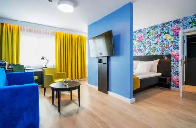 a room with a bed and a couch and a table at Thon Hotel Moldefjord in Molde
