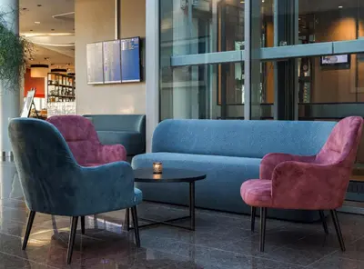 a lobby with two chairs and a couch and a table at Clarion Hotel Bergen Airport in Bergen