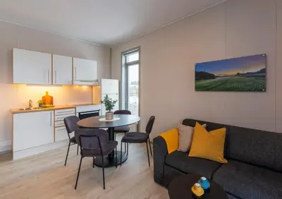 a living room with a couch and a table at Vikingskipet Hotell in Hamar