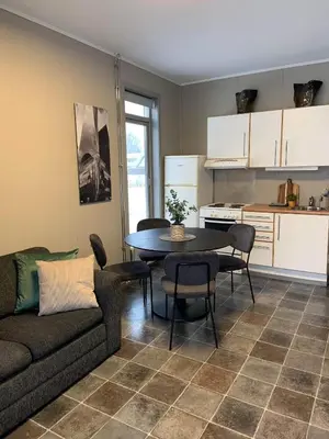 a living room with a couch and a table at Vikingskipet Hotell in Hamar