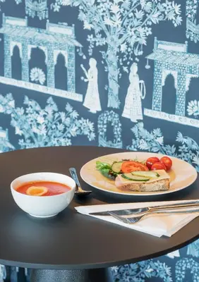 a table with a plate of food and a bowl of soup at Thon Hotel Orion in Bergen
