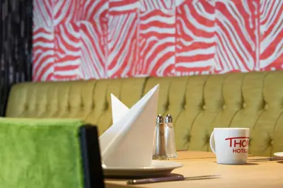 a table with a white paper boat on top of it at Thon Hotel Orion in Bergen
