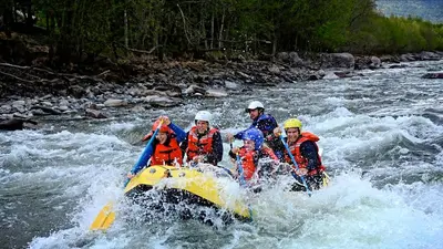 a group of people on a raft in a river at Herangtunet Mountain Lodge in Heggenes