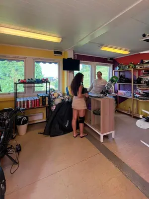 a woman standing at a counter in a store at Gjøvik Hovdetun Hostel in Gjøvik