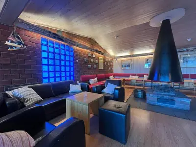 a living room with couches and a brick wall at Gjøvik Hovdetun Hostel in Gjøvik