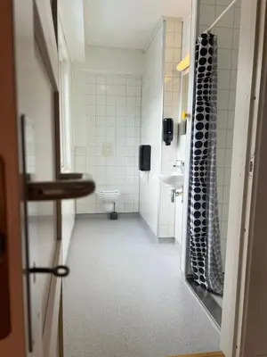 a bathroom with a toilet and a sink at Gjøvik Hovdetun Hostel in Gjøvik