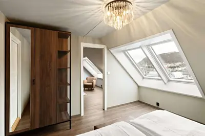 a bedroom with a bed and a chandelier at Ole Bull, Best Western Signature Collection in Bergen