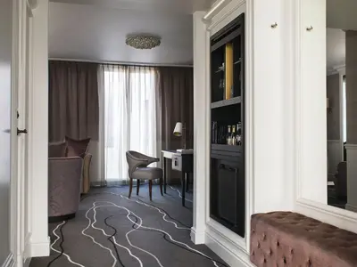 a hotel room with a desk and a room at Britannia Hotel in Trondheim