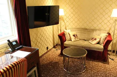 a hotel room with a couch and a table at Det Hanseatiske Hotel in Bergen